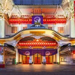 Tokyo, ginza - july 25 2023: Entrance of Kabukiza theater dedicated to the traditional Japanese kabuki art which the white facade is adorned by golden decorations lighted with paper lanterns at night.