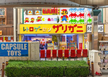Téléchargez les photos : Osaka, japon - dec 04 2022 : Retro Game Center Zarigani situé à Tsutenkaku Hondori Shopping Street avec des machines à jouets capsule et des jeux emblématiques comme Super Mario Bros, Pac-Man ou Space Invaders. - en image libre de droit