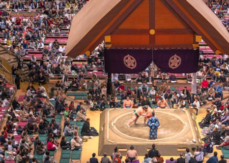 Photo for Japanese Dohyo used by sumo wrestling tournaments made with a circle of rice-straw bales on a square platform overlooked by a Tsuriyane roof at Kokugikan Arena. - Royalty Free Image