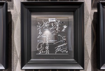 Photo for Tokyo, japan - sep 08 2023: Black shikishi board framed and signed by the voice actresses and actors, the director and the mangaka of the Japanese anime City Hunter Angel Dust on a cinema wall. - Royalty Free Image