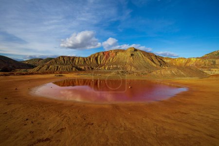 Photo for Mining landscape of Mazarrn, Murcia, Spain, where a small red puddle can be seen due to the iron from the extracted minerals - Royalty Free Image