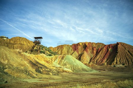 Photo for View of the abandoned and colorful mining landscape of Mazarrn, Region of Murcia with iron extraction tower - Royalty Free Image