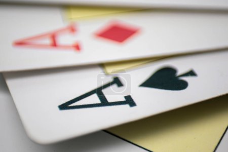 Photo for Close-up of playing cards with the ace of diamonds out of focus and the ace of spades in focus - Royalty Free Image