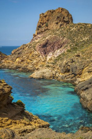 Photo for View of a hidden and spectacular cove on the coast of Cartagena, Region of Murcia, Spain with crystal clear and turquoise blue waters with land rocks of various colors - Royalty Free Image