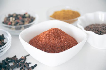 Photo for Small jars with ingredients of different spices, paprika, curry, anise, pepper, cloves. - Royalty Free Image