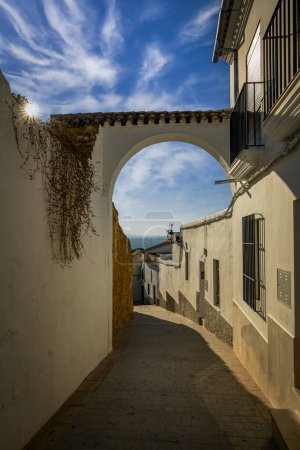 Photo for Nice alley with arch in the old town of Osuna, Seville, Andalusia, Spain, in midday light - Royalty Free Image
