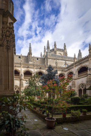 Beautiful Gothic cloister of the monastery of San Juan de los Reyes, Toledo, Castilla la Mancha, Spain, with its landscaped courtyard