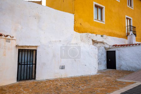 Colorful detail of the facades of some typical cave houses in the old town of Chinchilla de Montearagon in Albacete, Castilla la Mancha, Spain