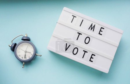 Time to vote. Democracy concept. Message board and clock flat lay. Election day. Minimalistic design