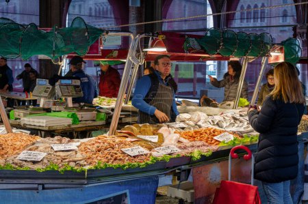 Photo for Venice, Italy- Feb 23, 2023: People shopping for fish at The Rialto Fish Market in Venice, Italy - Royalty Free Image