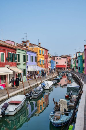 Photo for Burano, Italy- Feb 25, 2023; Colorful houses along the main canal with small boats in Burano Italy - Royalty Free Image