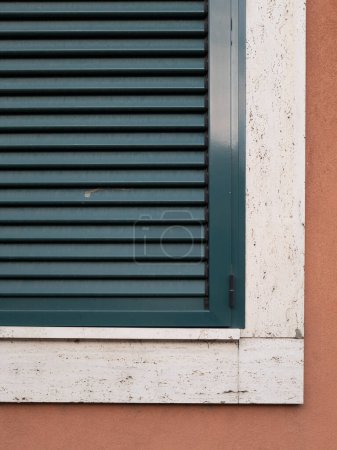 Single window with green shutters set on the wall, Belgrade, Serbia