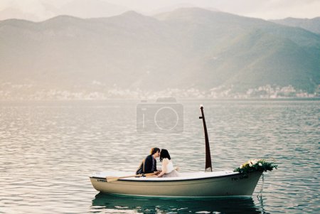 Photo for Man and woman kiss in a boat in the sea. High quality photo - Royalty Free Image