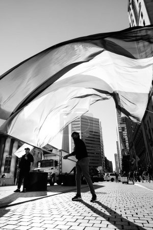 Photo for Anti-war march in Toronto by Palestinians against Israels aggression in Gaza. Citys peaceful protest against Israel-HAMAS war. Protesters wave flags against. Palestinian genocide. - Royalty Free Image