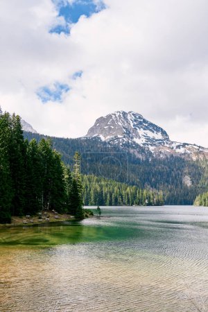 Photo for Transparent Black Lake with shores covered with coniferous forest at the foot of Mount Bobotov Kuk. Durmitor, Montenegro. High quality photo - Royalty Free Image