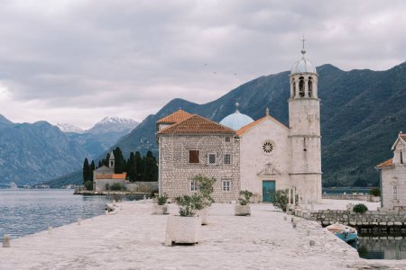 Photo for Church of Our Lady on the Rocks on an island in the Bay of Kotor with mountains in the background. Montenegro. High quality photo - Royalty Free Image