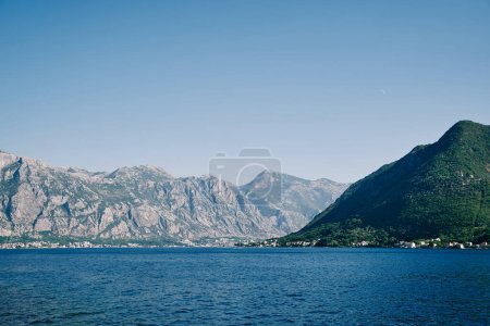Blue sea at the foot of a high mountain range. High quality photo