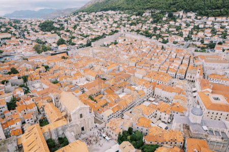 Square in front of the Cathedral of St. Ignatius against the backdrop of old stone buildings. Dubrovnik, Croatia. Drone. High quality photo