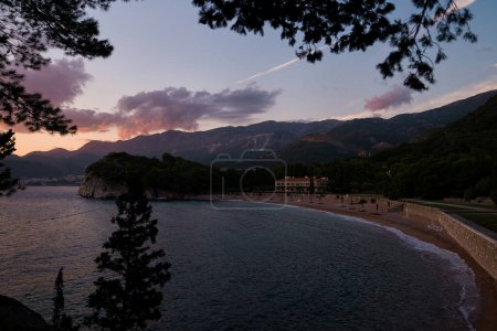 Beach near Villa Milocer at the foot of the mountains at sunset. Montenegro. High quality photo