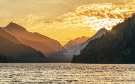 Photo for Sunsetting behind the mountains of Muchalat lake near Gold River on Vancouver Island, British Columbia, Canada. - Royalty Free Image