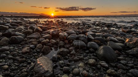 Photo for Fossil beach is a great place to catch a sunset on Hornby Island, Brtiish Columbia, Canada. - Royalty Free Image