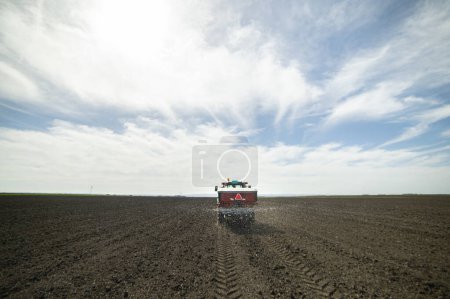 Tractor spreading artificial fertilizers. Transport, agricultural.
