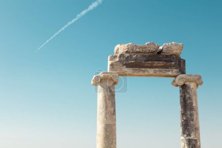 Antique greek columns on a blue sky background