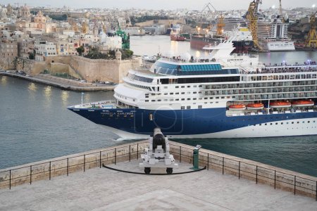 Photo for VALLETTA, MALTA - OCTOBER 30 2022: Marella Exxplorer cruise ship leaving Valletta's harbour at sunset - Royalty Free Image
