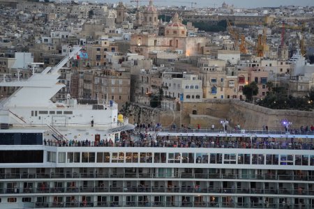 Photo for VALLETTA, MALTA - OCTOBER 30 2022: Marella Exxplorer cruise ship leaving Valletta's harbour at sunset - Royalty Free Image