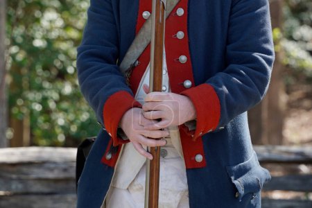 musket on hands of American Revolution british soldier settler in Yorktown, Virginia USA