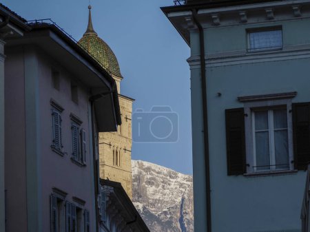 The Church of Santa Maria Maggiore, Trento, Italy view from dome place with snowy dolomites mountains background