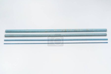 Photo for Iron threaded stud on a white background. metal rod with thread on a light background. construction long bolt with thread for fastening - Royalty Free Image