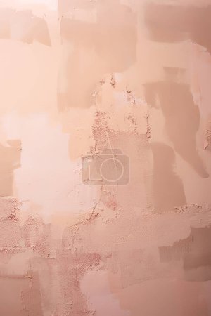 the texture of the peach-colored wall. plastered wall with colored paint. a textured wall made of putty in a photo studio