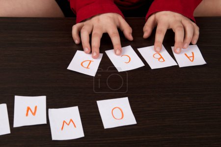 Photo for English alphabet cards. The child learns letters. Education in kindergarten. Elementary School. Learning to read - Royalty Free Image