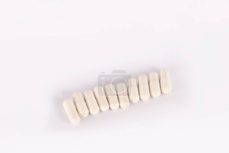 Photo for White pills in capsules on a white background. Medical capsule pills, top view. Packaging for tablets, capsules or supplements. The concept of medicine and health. Vitamins for health and sports - Royalty Free Image