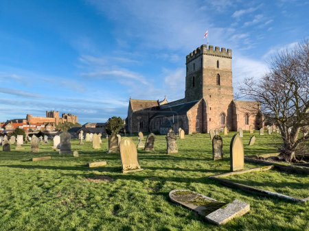 Téléchargez les photos : Bamburgh Castle viewed from Bamburgh Parish Church in Northumberland on the northeast coast of England. - en image libre de droit