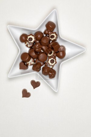 Photo for Milk chocolates in a star shaped bowl - Royalty Free Image