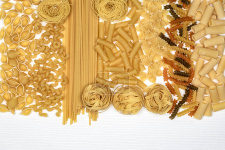 Photo for Types of Pasta - Linguine, Rigatoni, Spirali, Farfalle, Tagliatelle, Tricolore Fusilli, vermicelli and conchiglie. - Royalty Free Image