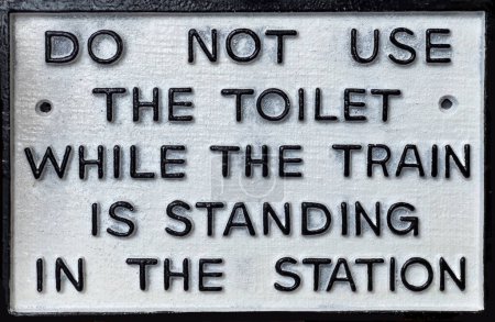 Photo for Vintage British railway sign - Do not use the toilet when the train is in the Station - Royalty Free Image