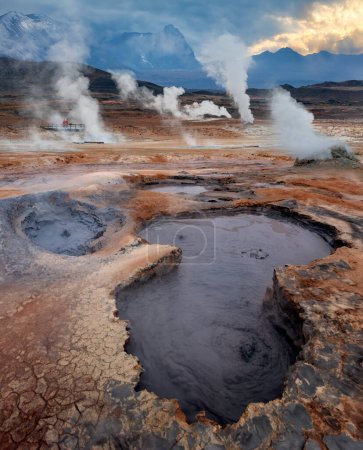 Boiling mud pools and volcanic steam vents at Namaskard Geothermal Area near Lake Myvatn in northern Iceland.