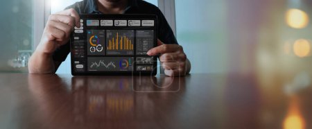 Photo for Businessman showing digital tablet with data growth graph and progress of business and analyzing financial and investment information, business planning and strategy. - Royalty Free Image