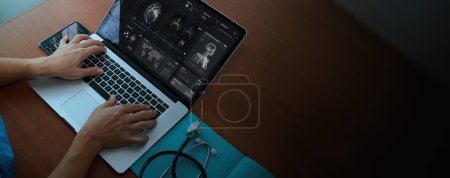 Photo for Above view of Doctor using technology document management on computer system management for cardiologist Specialist in treating heart disease for treatment in hospital . - Royalty Free Image