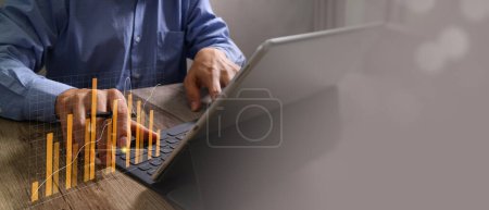 Photo for Businessman use laptop and tablet analyzing company growth, future business growth arrow graph, development to achieve goals, business outlook, financial data for long term investment. - Royalty Free Image