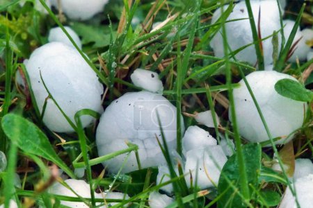 Giant hailstones from a storm (in the Dordogne, France April 2024) resulting in damaged roof tiles and a dented car bonnet and roof