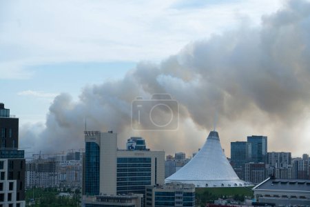 Photo for Astana, Kazakhstan, June 23, 2023. The steppe is burning on the border of the capital, tubers of smoke in the air above the city. High quality photo - Royalty Free Image