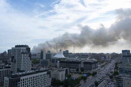 Photo for Astana, Kazakhstan, June 23, 2023. The steppe is burning on the border of the capital, tubers of smoke in the air above the city. High quality photo - Royalty Free Image