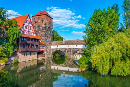 Historical old town with view of Weinstadel building, water tower, Henkerbrucke bridge and Henkerturm tower in Nurnberg, Germany..