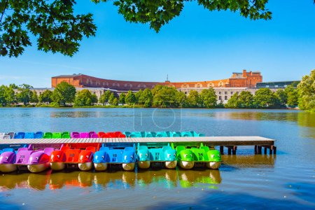 Photo for Paddle boats and former Nazi congress hall in Nurnberg, Germany. - Royalty Free Image