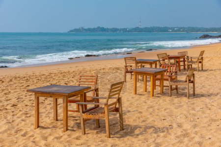 Photo for Chair and a table at Marakolliya beach, Sri Lanka. - Royalty Free Image