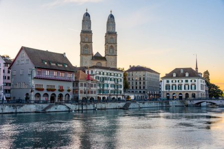 Sunrise view of Limmat river with Grossmuenster cathedral in Zurich, Switzerland.